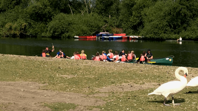 Group of peole in canoes on River Thames